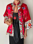 Collana vintage in stile orientale con ciondolo rotondo in cinabro rosso e nappa couture
