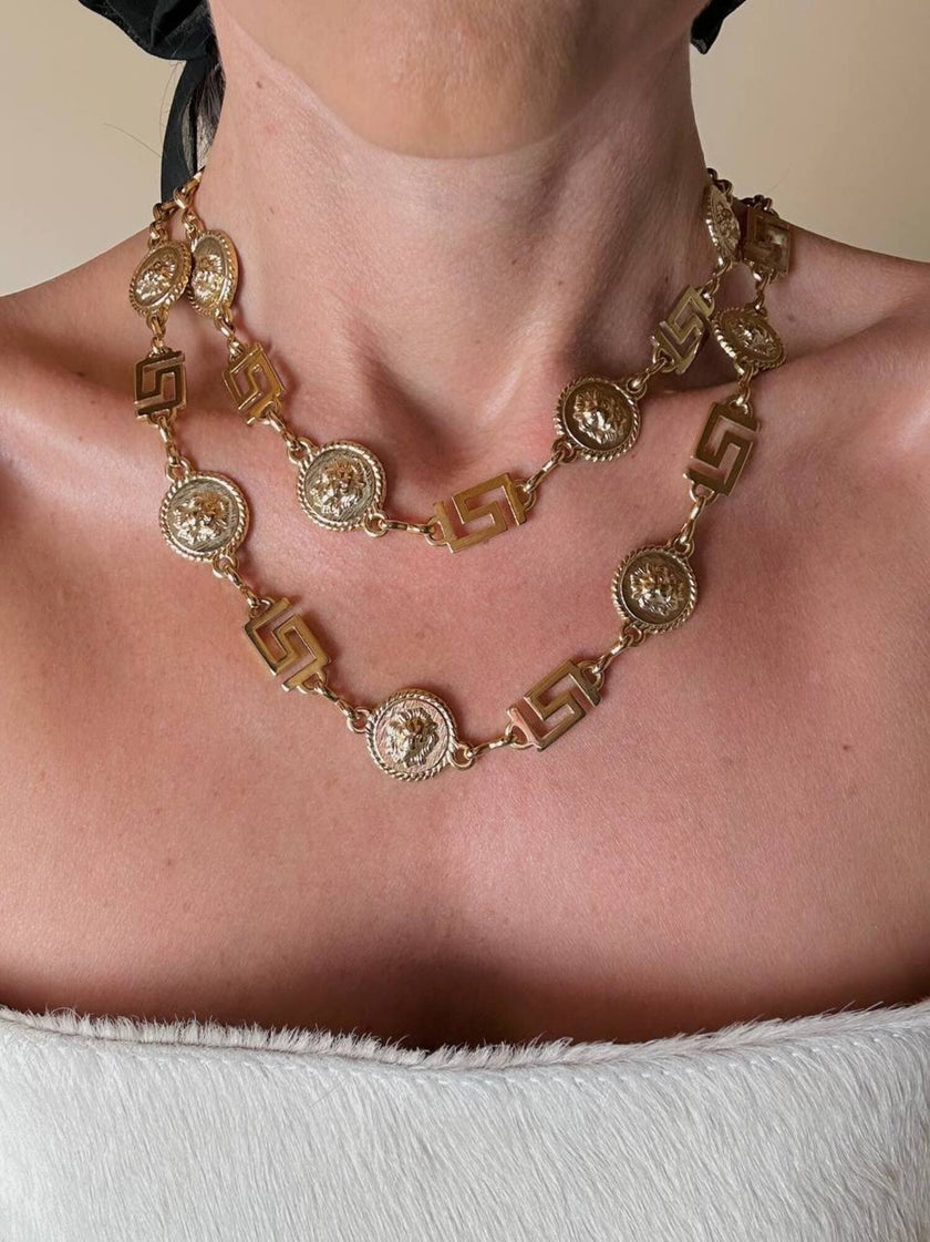 Cintura/collana dorata composta da greche e teste di leone