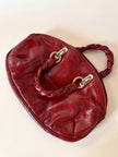 Borsa in pelle rosso bruciato con manici a treccia