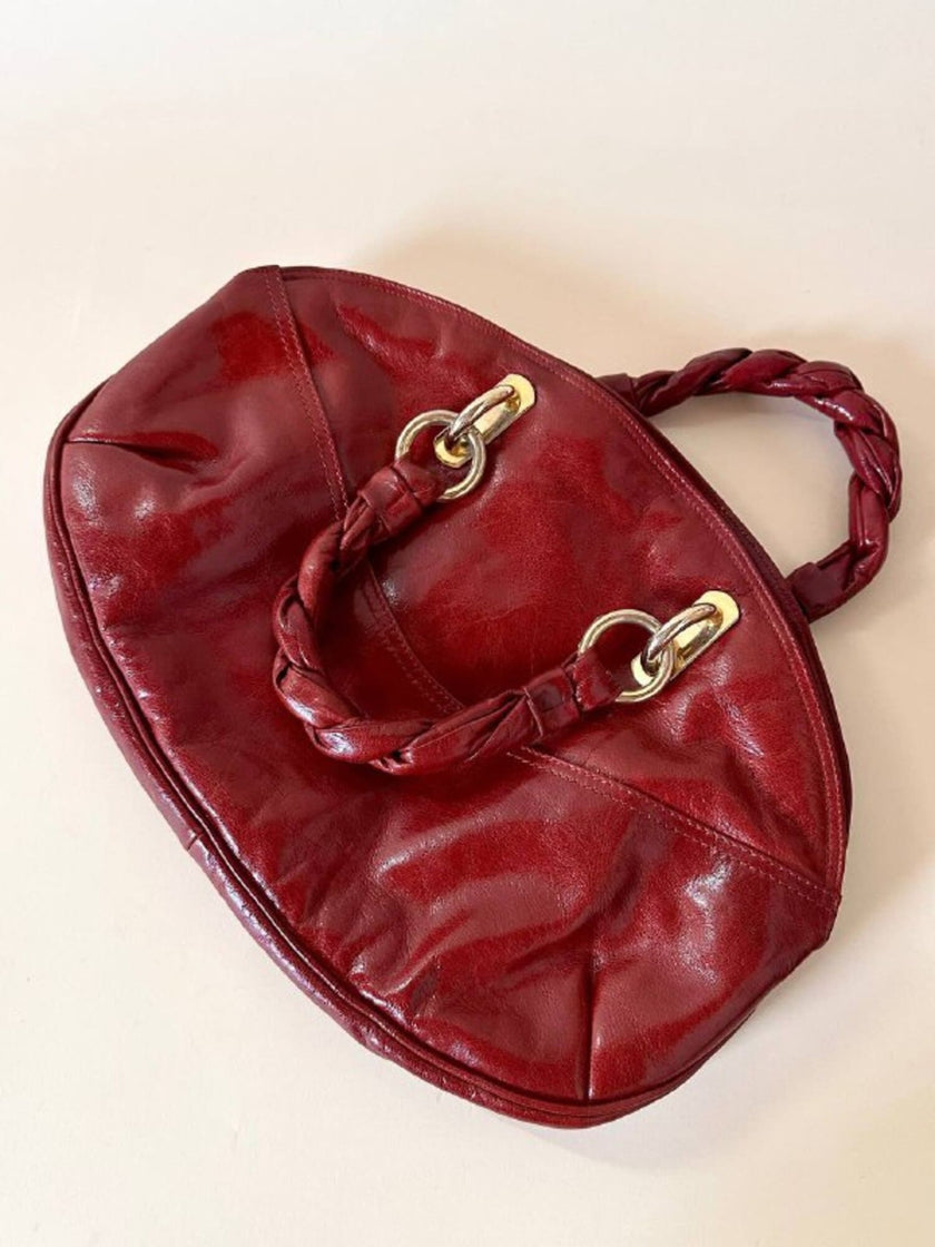 Borsa in pelle rosso bruciato con manici a treccia