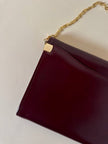 Pochette in pelle spazzolata bordeaux con tracolla in catena