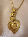 Collana dorata con ciondolo pendente a cuoricini “Yves Saint Laurent”