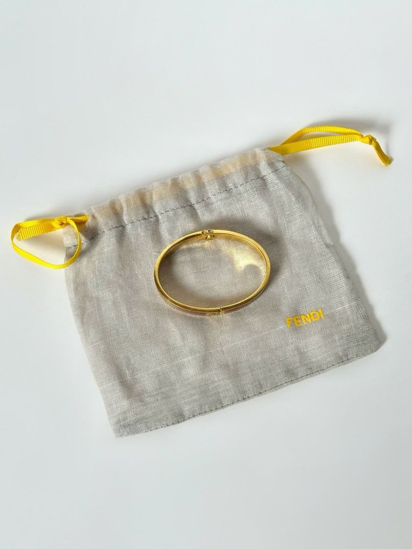 Bracciale vintage Fendi in metallo oro rifinito con smaltato grigio e rosso