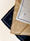 Foulard in seta beige con profili e logo bianchi “Yves Saint Laurent”