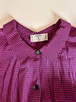 Camicia in seta a quadretti fucsia e neri con con fiocco al collo “Valentino”