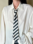 Cravatta in raso jacquard a righe diagonali bianche e nere