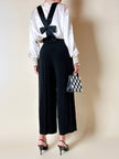 Pantalone nero con bretelle e maxi fiocchi in raso “Moschino Cheap and Chic”