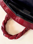 Borsa in pelle rosso bruciato con manici a treccia