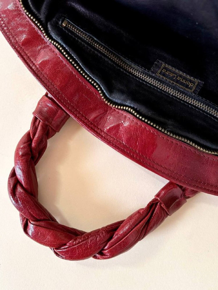 Borsa in pelle rosso bruciato con manici a treccia
