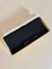 Pochette nera con fiocco in tessuto canneté