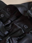 Pantalone nero con bretelle e maxi fiocchi in raso “Moschino Cheap and Chic”