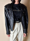 Giacca biker vintage in pelle nera con borchie dorate testa di medusa