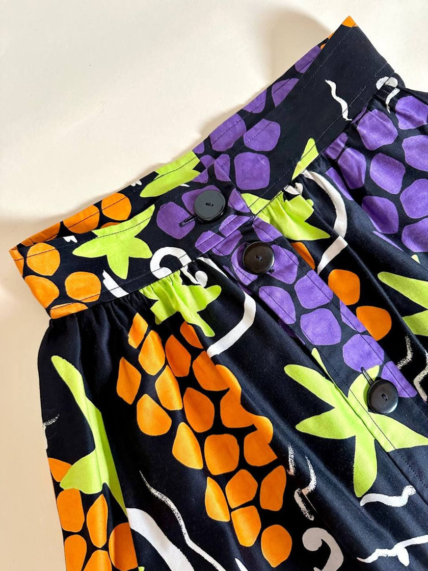 Gonna a ruota con abbottonatura frontale e fantasia a grappoli d’uva “Yves Saint Laurent”