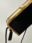 Borsa vintage in velluto nero con struttura dorata e nappe laterali