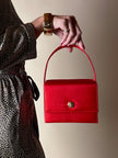 Mini bag vintage Versace Profumi in raso rosso con borchia medusa
