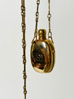 Collana vintage Gucci dorata con piccola bottiglia porta profumo