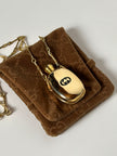 Collana vintage Gucci dorata con piccola bottiglia porta profumo