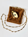 Collana vintage Gucci dorata con piccola bottiglia porta profumo
