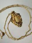 Collana vintage dorata con ciondolo a forma di bottiglia di profumo
