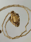 Collana vintage dorata con ciondolo a forma di bottiglia di profumo