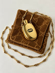 Collana vintage Gucci dorata con piccola bottiglia porta profumo