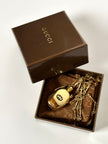 Collana vintage Gucci dorata con piccola bottiglia porta profumo