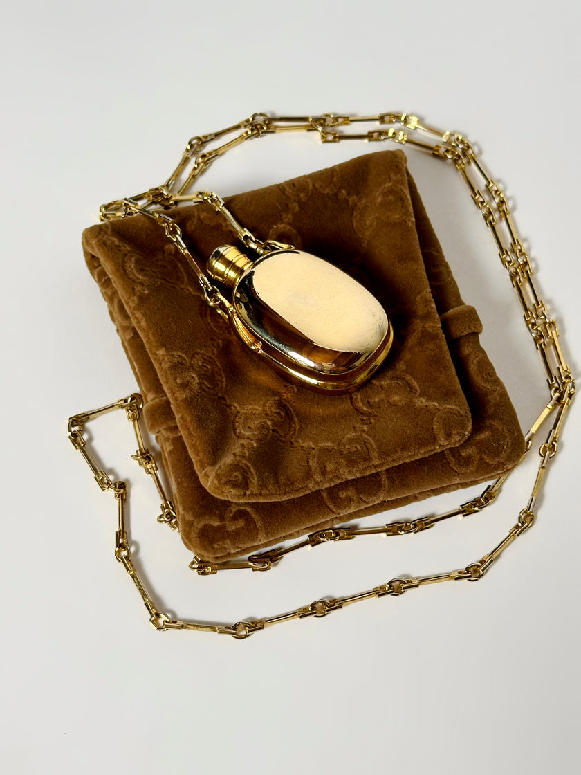 Collana vintage Gucci dorata con piccola bottiglia porta profumo