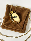 Collana vintage Gucci dorata con piccola bottiglia porta profumo