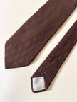 Cravatta Yves Saint Laurent in seta jacquard marrone con logo YSL allover