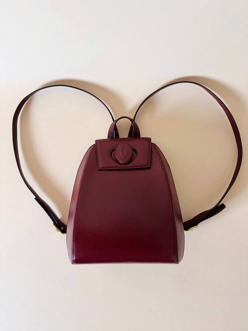 Sac à dos Must de Cartier en cuir bordeaux avec finitions dorées