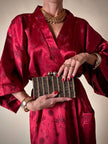 Clutch gioiello in seta nera con armatura di perline dorate “Rodo”