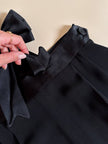 Pantalone nero con bretelle e maxi fiocchi in raso “Moschino Cheap and Chic”