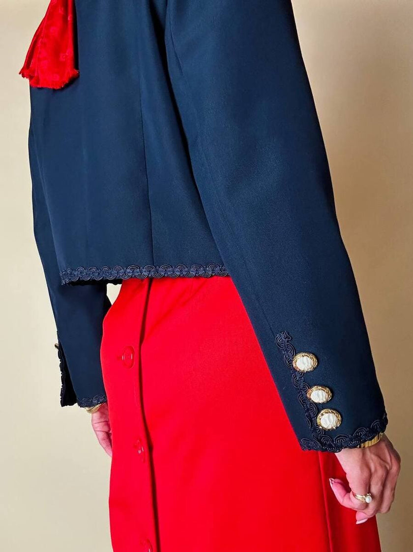 Bolero blu con bottoni gioiello e fiocchi “Max Dinè”