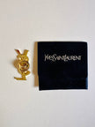 Spilla logo YSL dorata con dust nera “Yves Saint Laurent”
