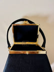 Mini bag a trapezio in ecopelle nera stampa lizard