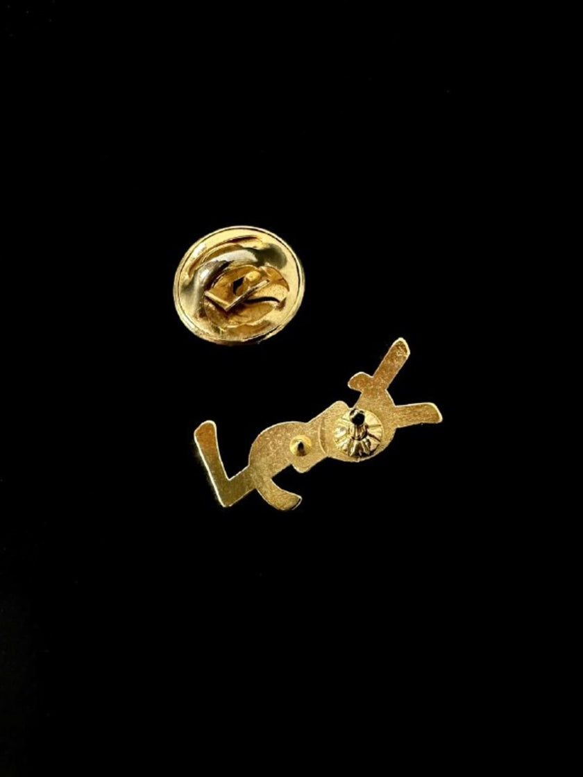 Mini spilla vintage logo Yves Saint Laurent in metallo dorato