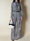 Jumpsuit in seta fantasia zebrata con maxi fiocco al collo