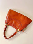 Borsa in pelle arancione zucca con doppi manici e hardware oro