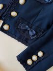 Bolero blu con bottoni gioiello e fiocchi “Max Dinè”