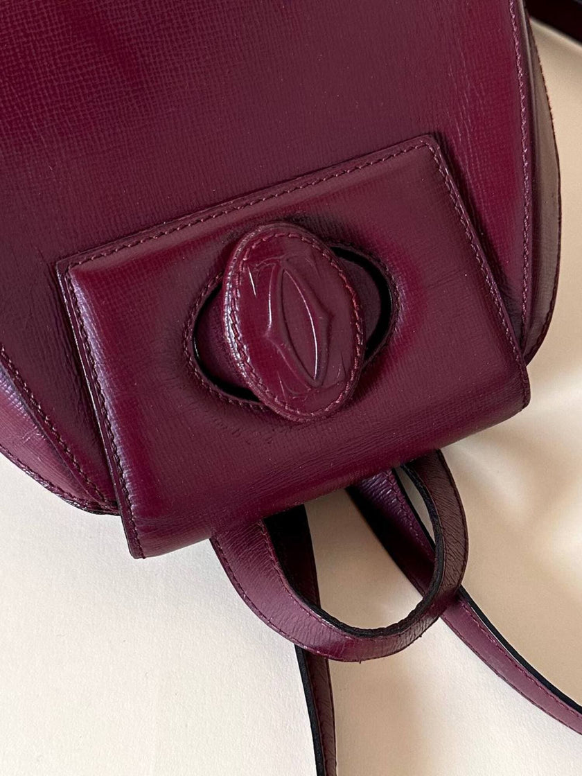 Sac à dos Must de Cartier en cuir bordeaux avec finitions dorées