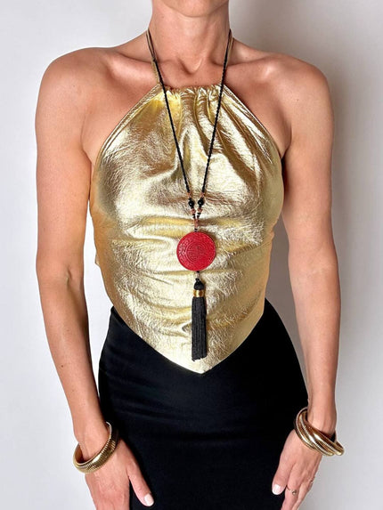 Top vintage con schiena nuda in pelle laminata oro