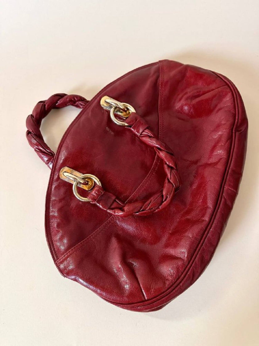 Borsa in pelle rosso bruciato con manici a treccia