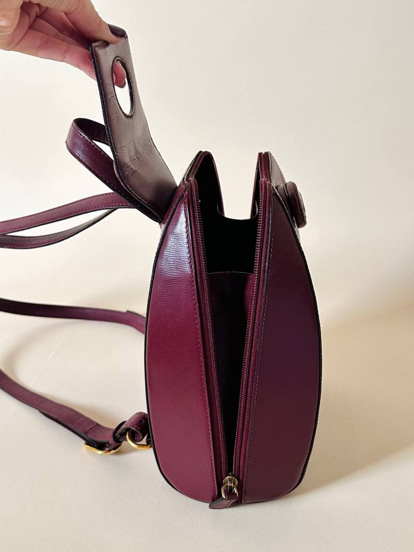 Sac à dos Must de Cartier en cuir bordeaux avec finitions dorées