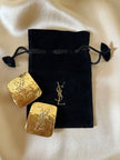 Maxi orecchini a clip dorati con logo YSL 
