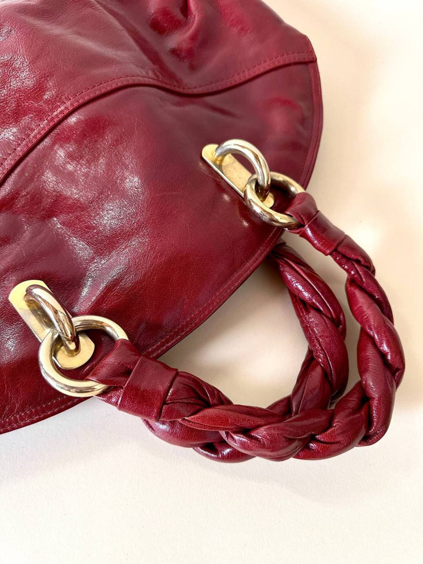 Borsa in pelle rosso bruciato con manici a treccia