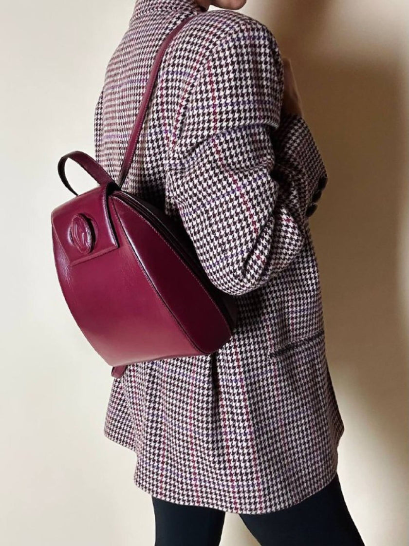 Sac à dos Must de Cartier en cuir bordeaux avec finitions dorées