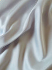 Maxi dress con schiena nuda in raso grigio perla “Mercí”