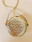 Borsa rotonda in midollino oro con tracolla in pelle laminata oro “Rodo”