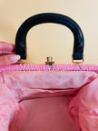 Borsa in rafia rosa lavorata con cordino in tinta