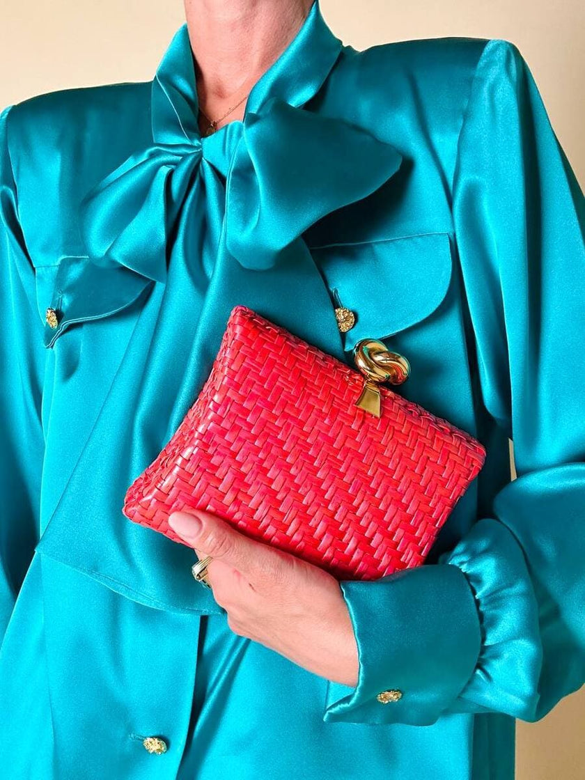 Borsa in midollino color geranio con chiusura a nodo e catena dorata “Rodo”
